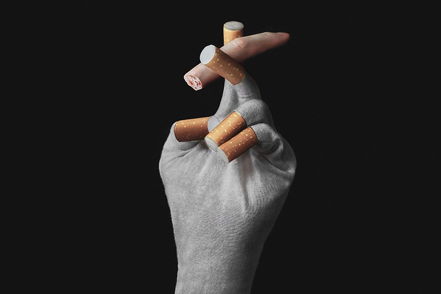 Fotografía artística conceptual, donde una mano de cigarrillos sujetan a un dedo humano como si fuese a fumar de el